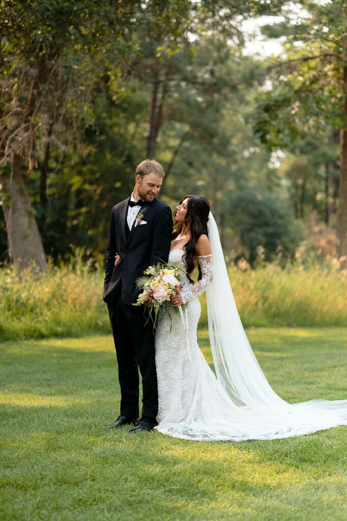 bride and groom surrounded by lush green landscapes during their lakeside wedding in bemidji mn