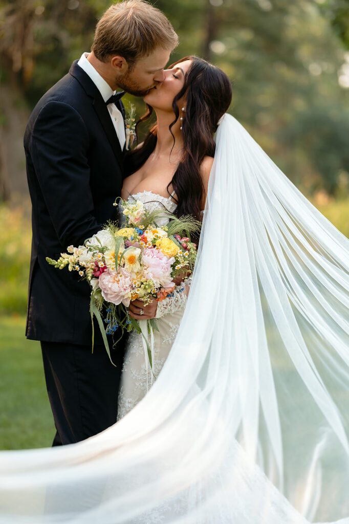 bride and groom surrounded by lush green landscapes during their lakeside wedding in bemidji mn