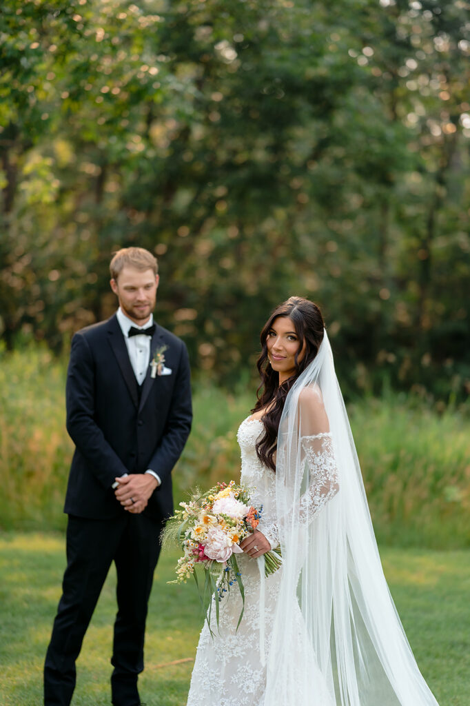 bride and groom surrounded by lush green landscapes during their lakeside wedding in bemidji mn