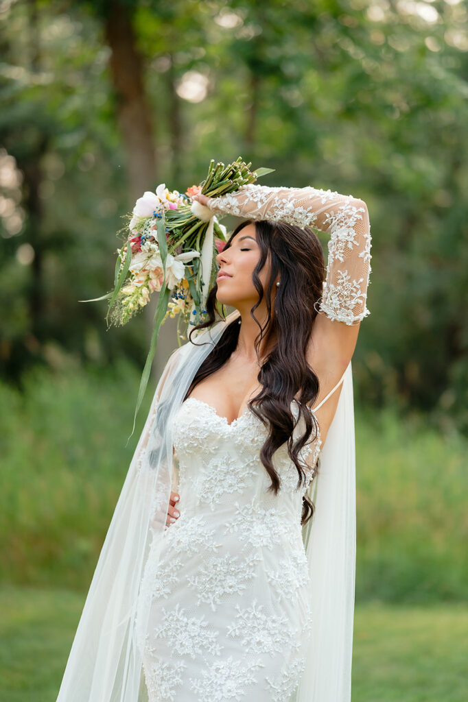 elegant bridal portrait surrounded by lush green landscapes during their lakeside wedding in bemidji mn
