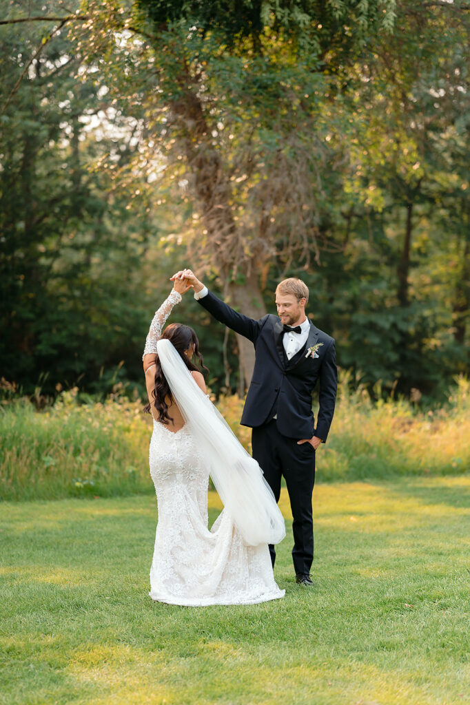 bride and groom surrounded by lush green landscapes during their lakeside wedding in bemidji mn