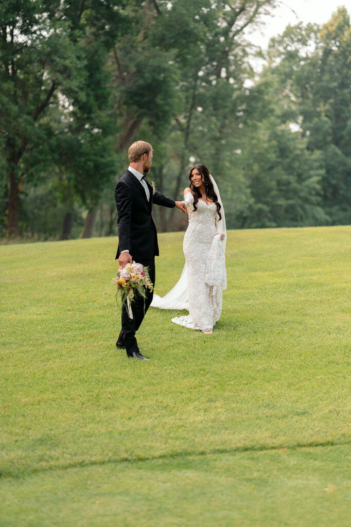 bride and groom surrounded by lush green landscapes during their lakeside wedding in bemidji mn