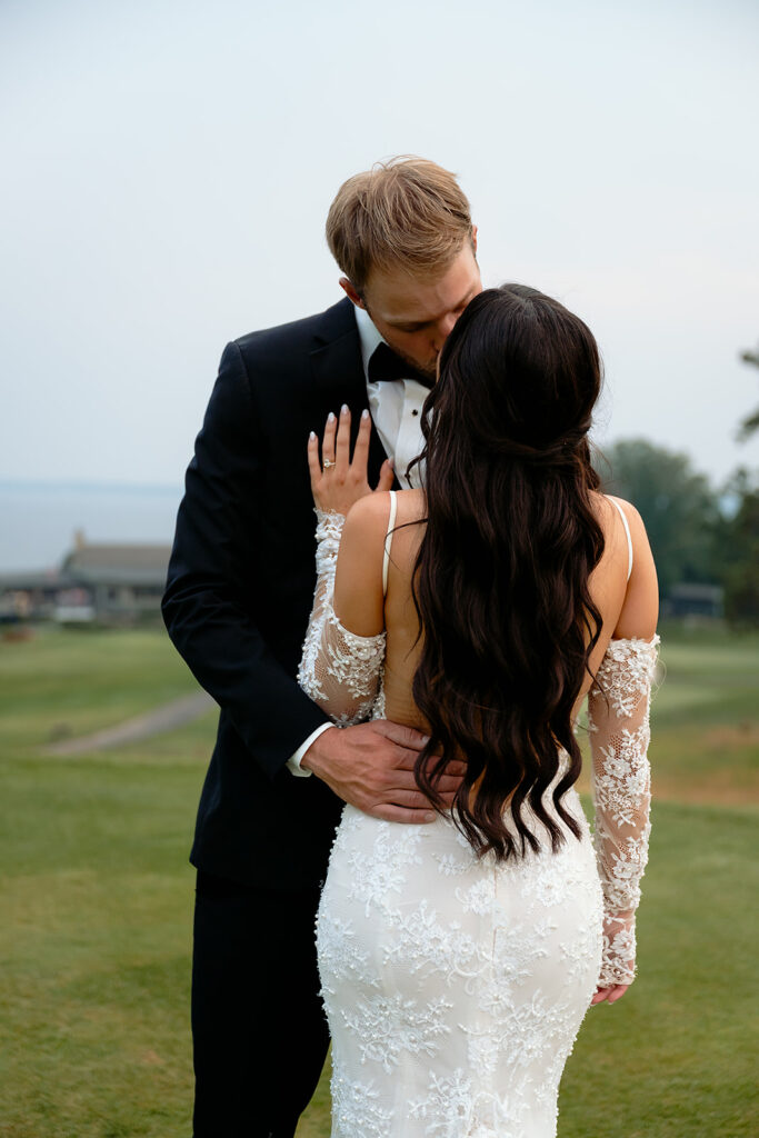 bride and groom surrounded by lush green landscapes during their lakeside wedding in bemidji mn