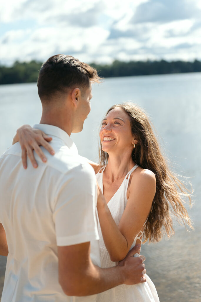 sweet couple standing in a lake during their minnesota engagement session
