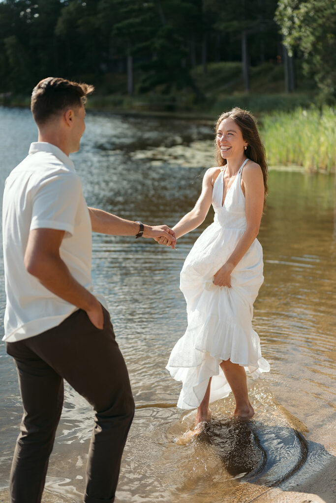 playful couple in the lake during their romantic Catalyst By Nature Link engagement session