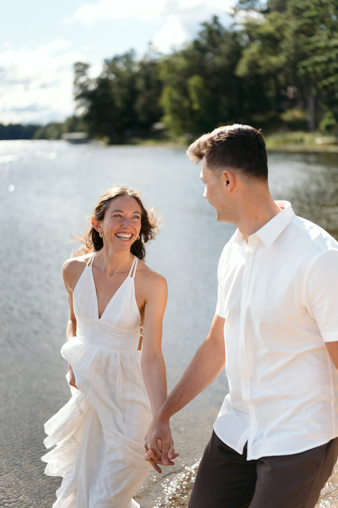 playful couple in the lake during their romantic Catalyst By Nature Link engagement session