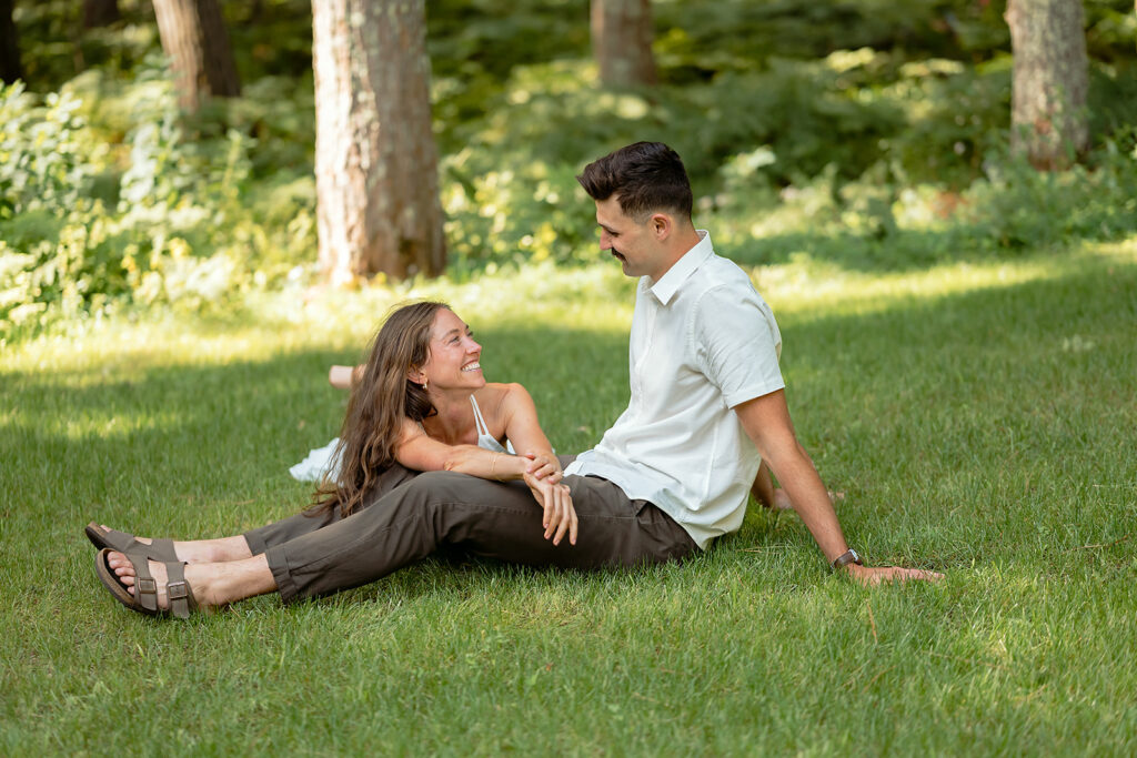 playful couple in a forest during their minnesota engagement session