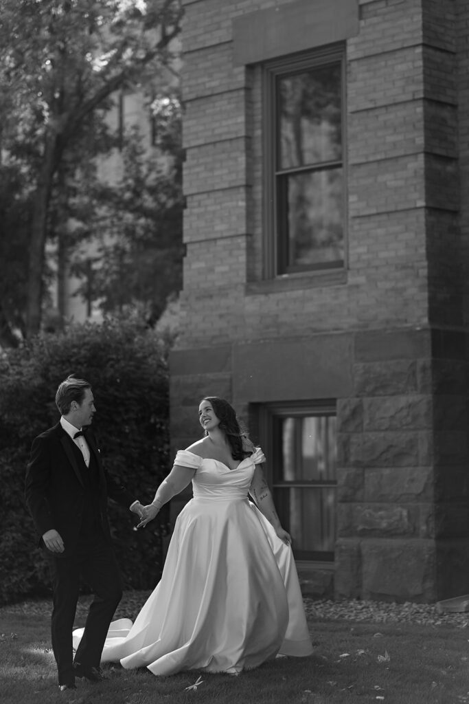 elegant bride and groom in front of Beltrami County Courthouse during their Minnesota courthouse wedding