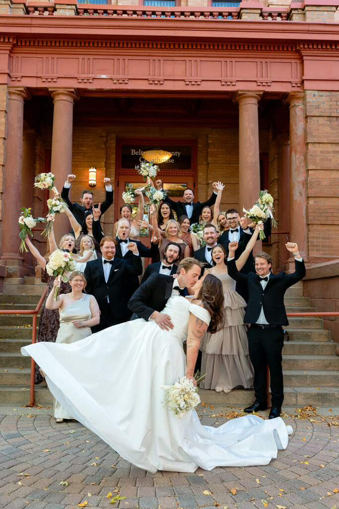 bride and groom and wedding party in front of Beltrami county courthouse