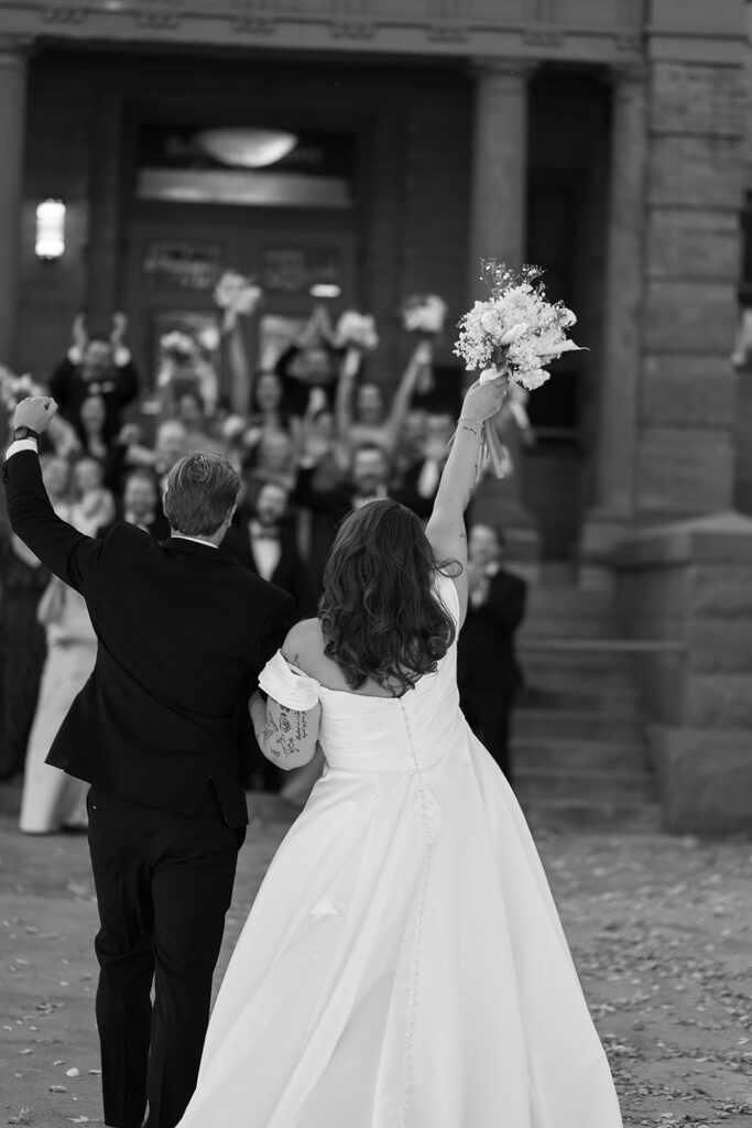 bride and groom and wedding party in front of Beltrami county courthouse