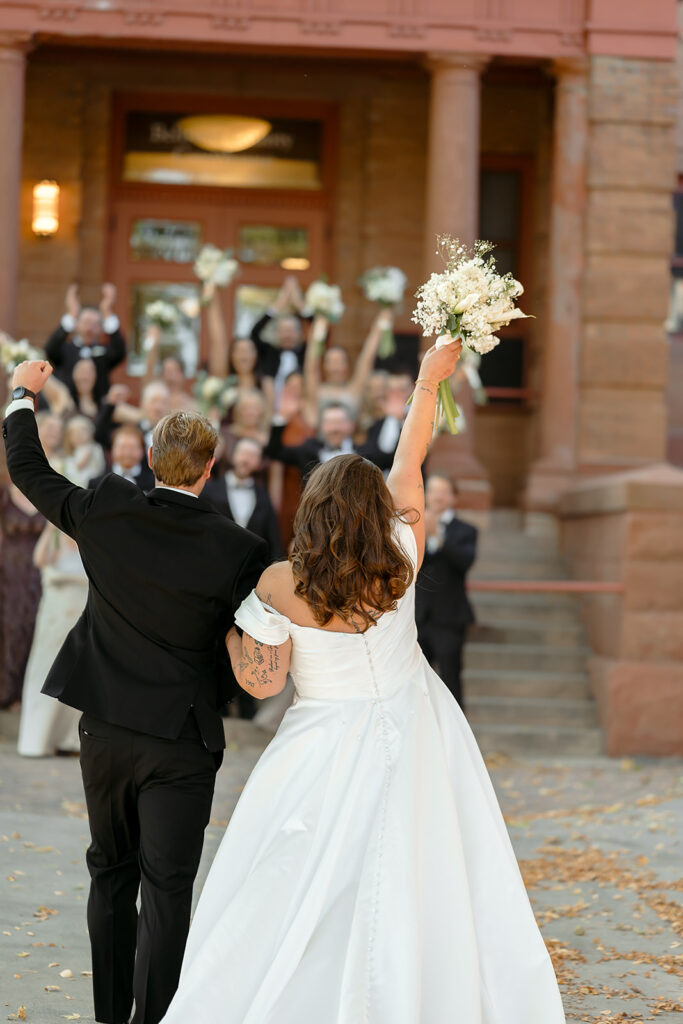 bride and groom and wedding party in front of Beltrami county courthouse