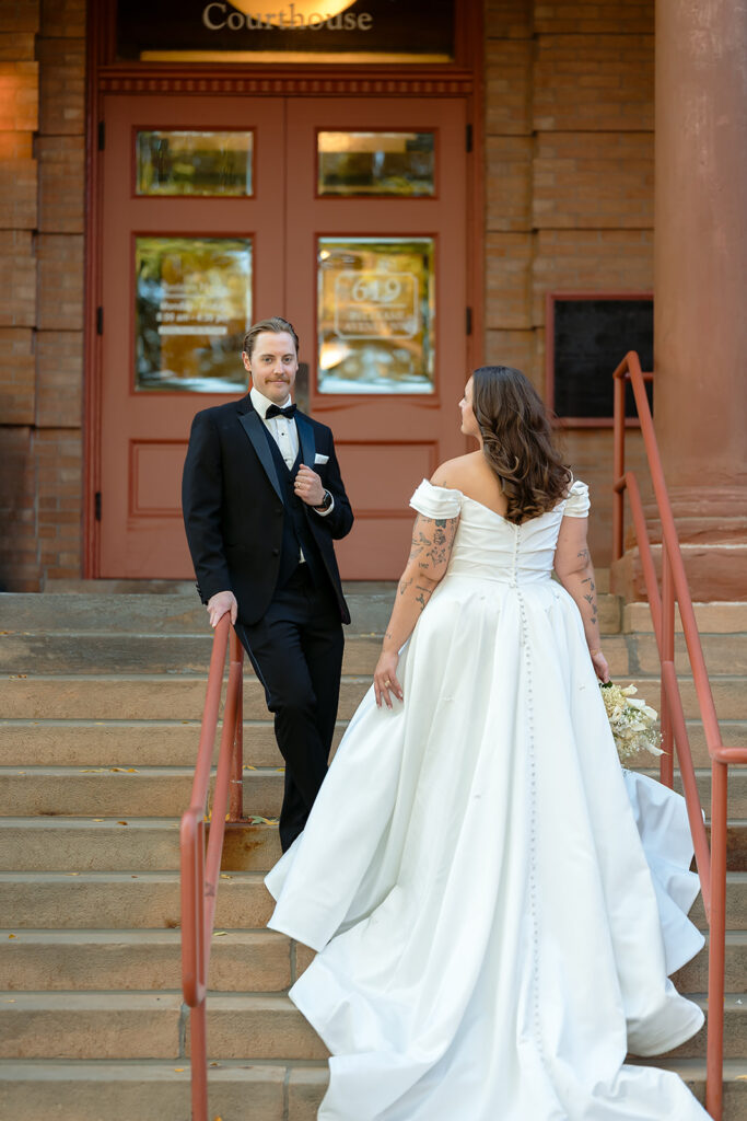 bride and groom on the steps of Beltramy county courthouse