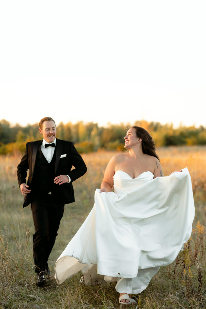 playful golden hour wedding portraits in a lush field