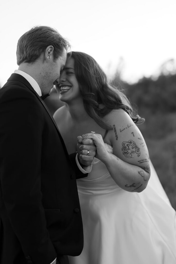 playful golden hour wedding portraits in a lush field