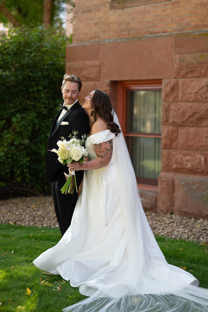 elegant bride and groom in front of Beltrami County Courthouse during their Minnesota courthouse wedding