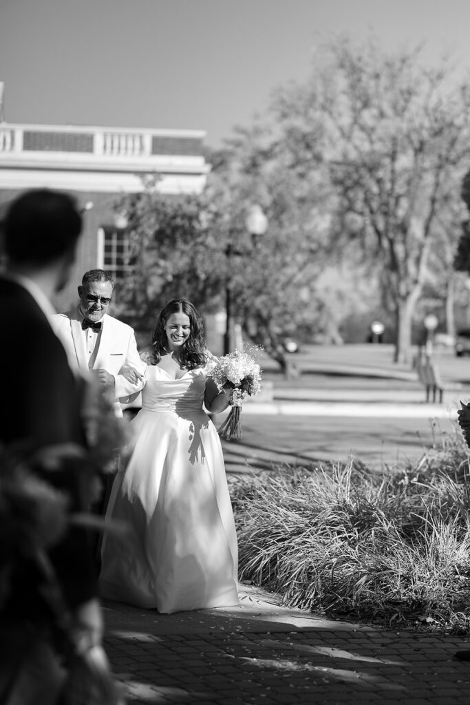 dad walking bride down the aisle for an outdoor courthouse wedding ceremony at Beltrami County Courthouse