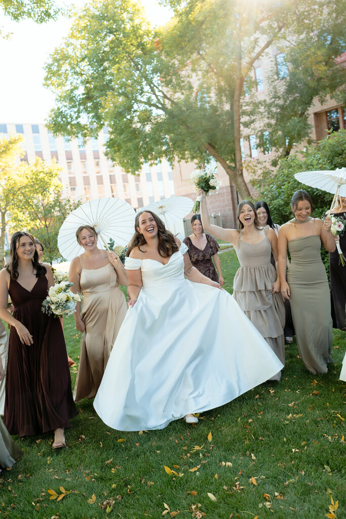 bride and bridesmaids cheering in front of Beltrami county courthouse