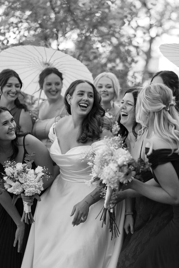 bride and bridesmaids cheering in front of Beltrami county courthouse
