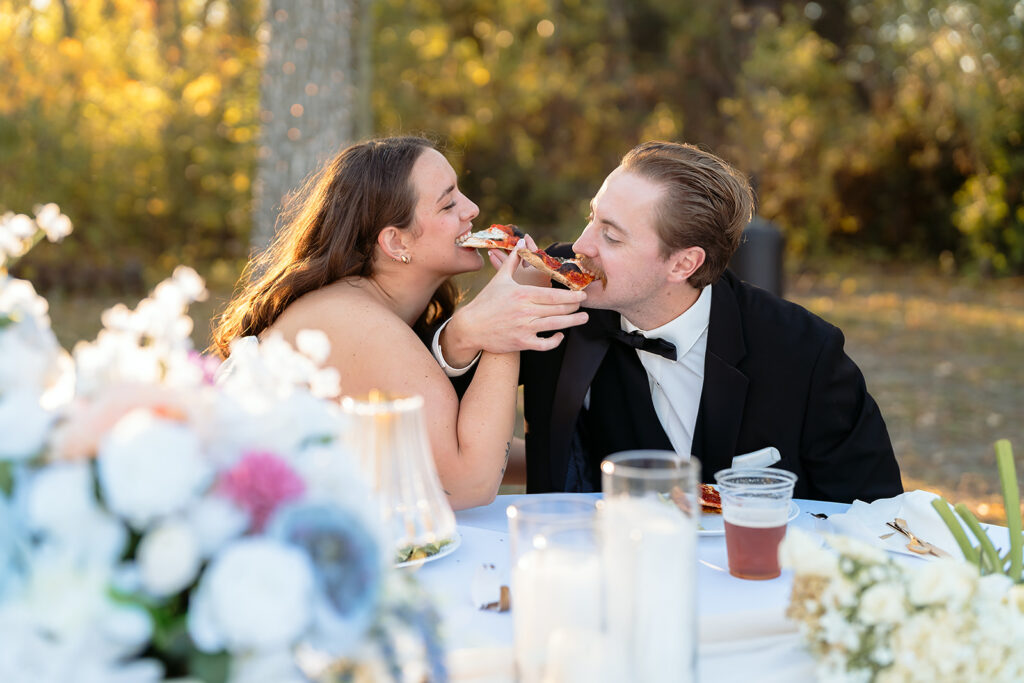 bride and groom eating pizza