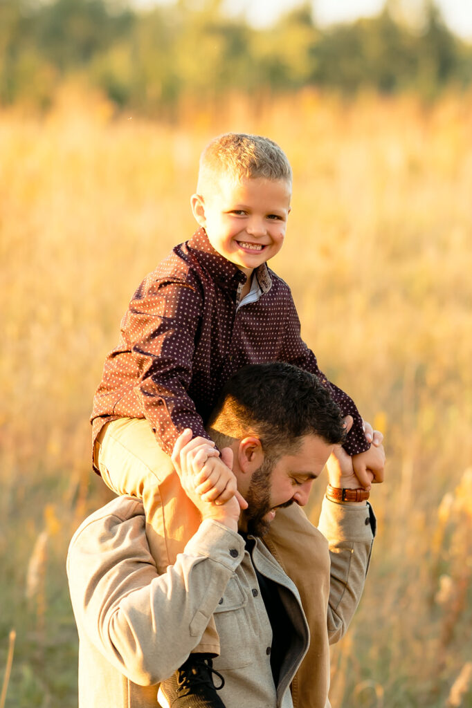 dad giving his son a piggy back ride