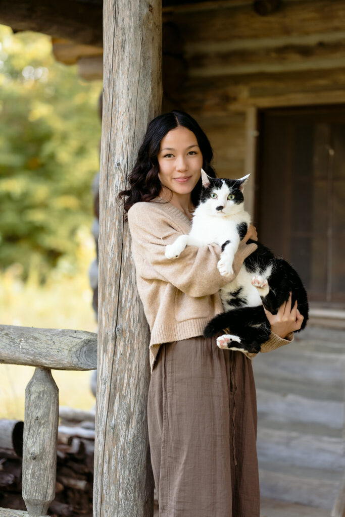 fall senior photos at a rustic cabin with her cat