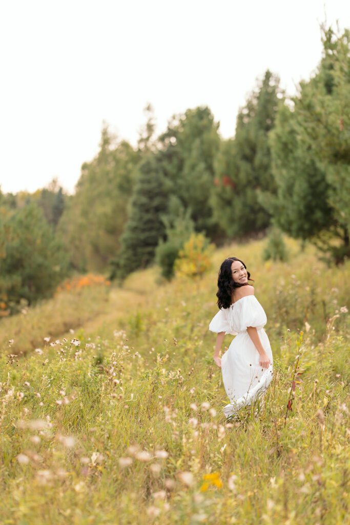 fall senior photos in a lush field in western minnesota