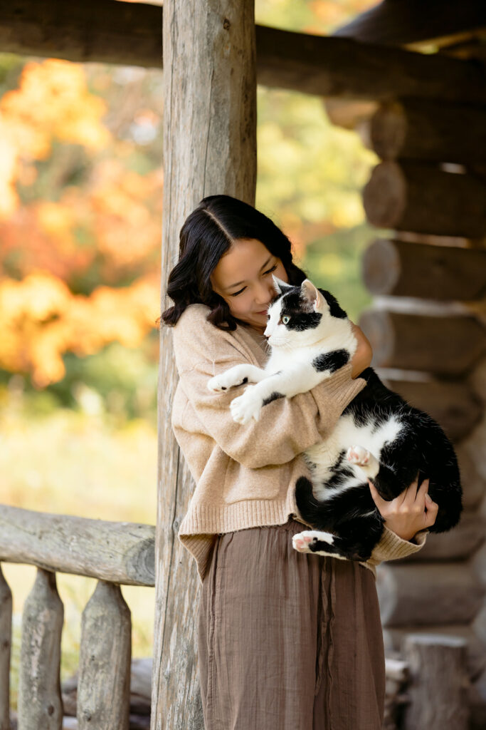fall senior photos at a rustic cabin with her cat