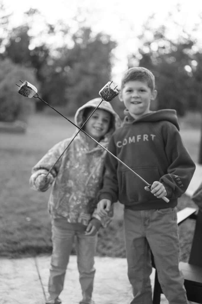 family making s'mores in their backyard