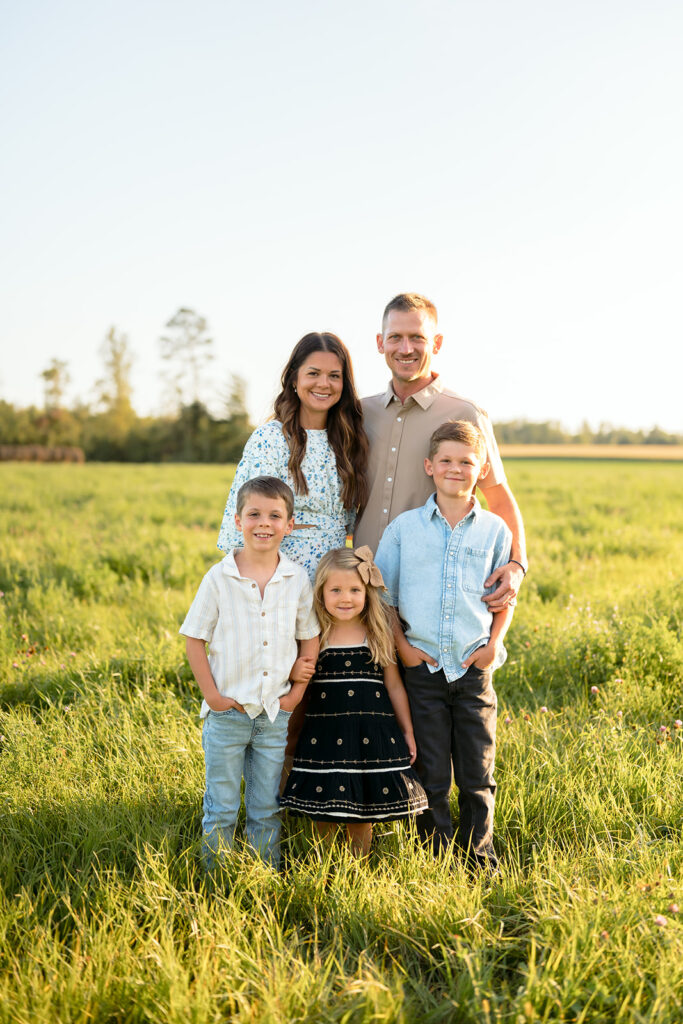 mom and dad and their three kids during their sweet family photos at home