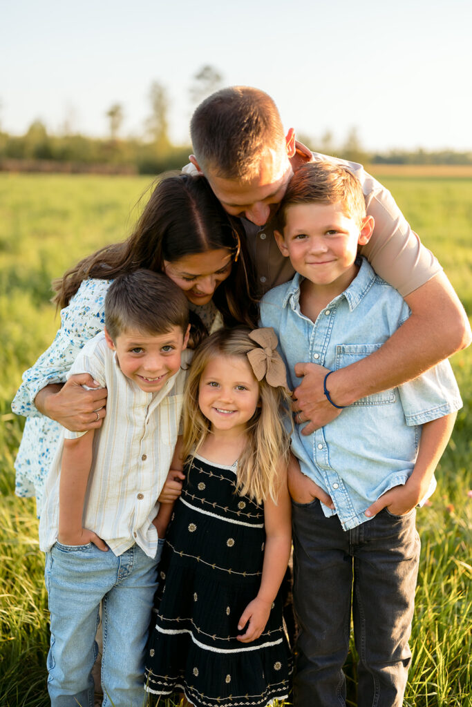 mom and dad and their three kids during their sweet family photos at home