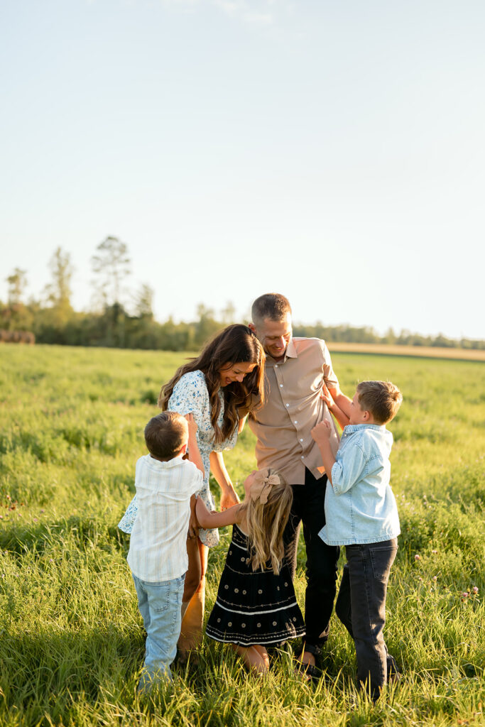 mom and dad and their three kids during their sweet family photos at home