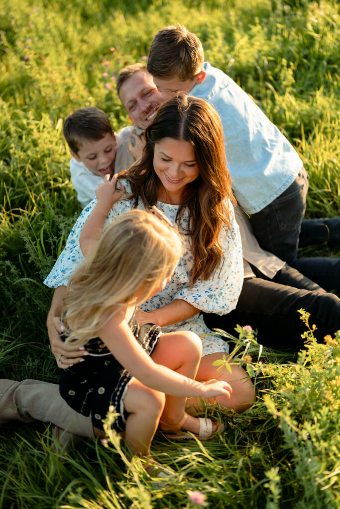 mom and dad and their three kids during their sweet family photos at home