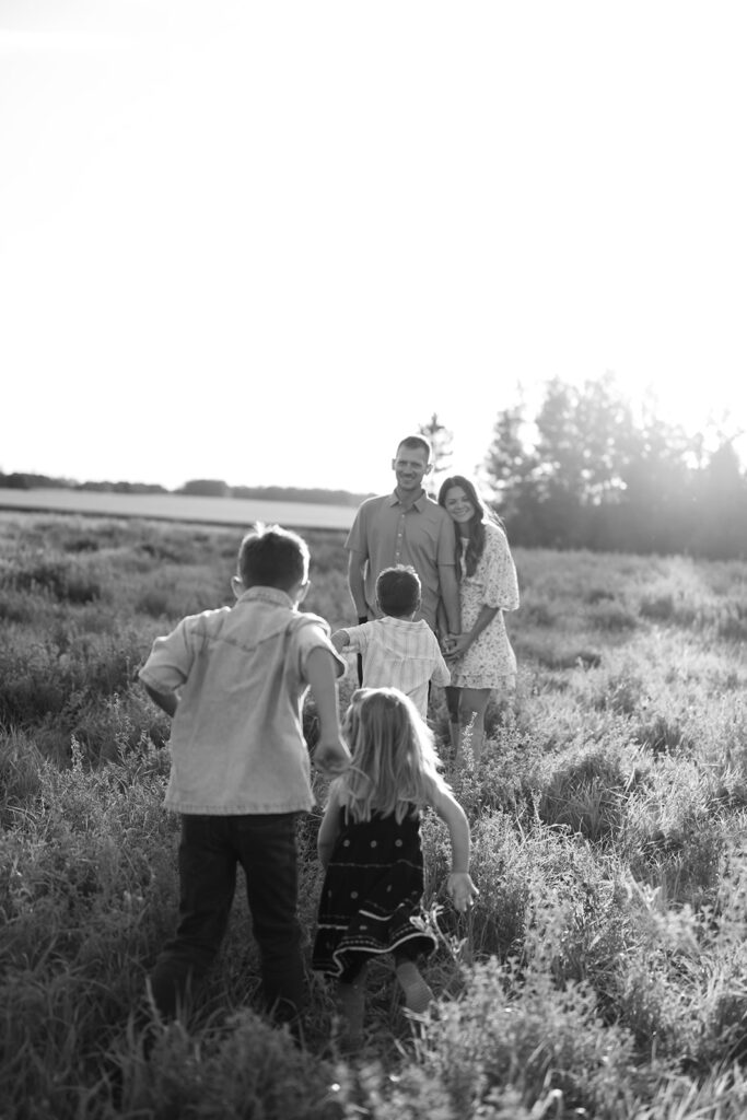 mom and dad and their three kids during their sweet family photos at home