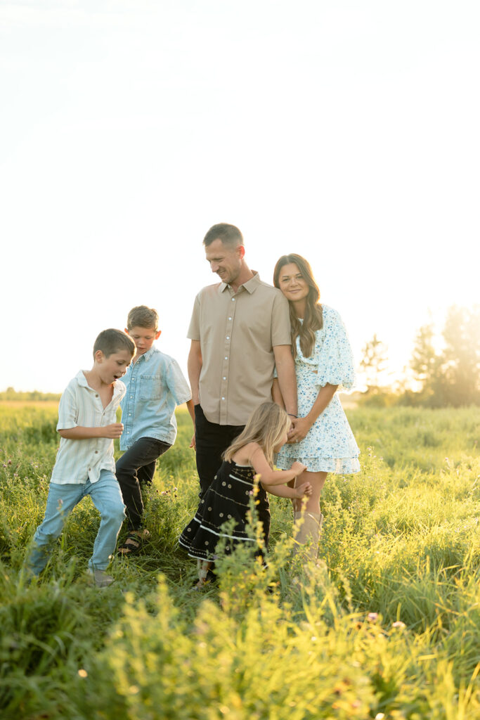mom and dad and their three kids during their sweet family photos at home