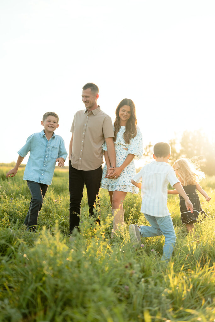 mom and dad and their three kids during their sweet family photos at home