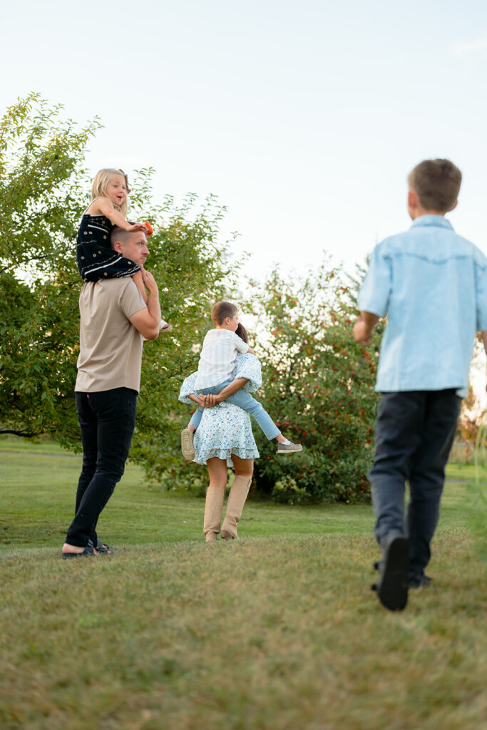 family apple picking in their backyard garden