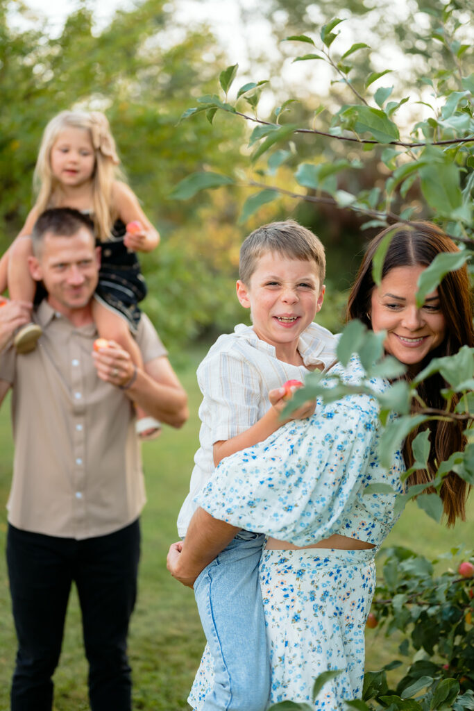 family apple picking in their backyard garden