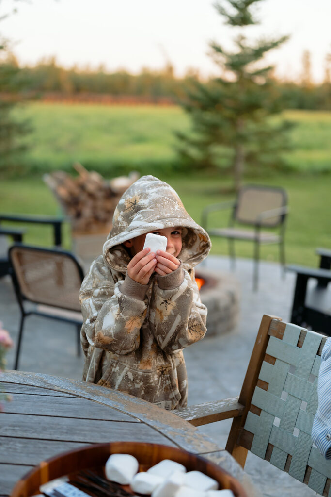 family making s'mores in their backyard