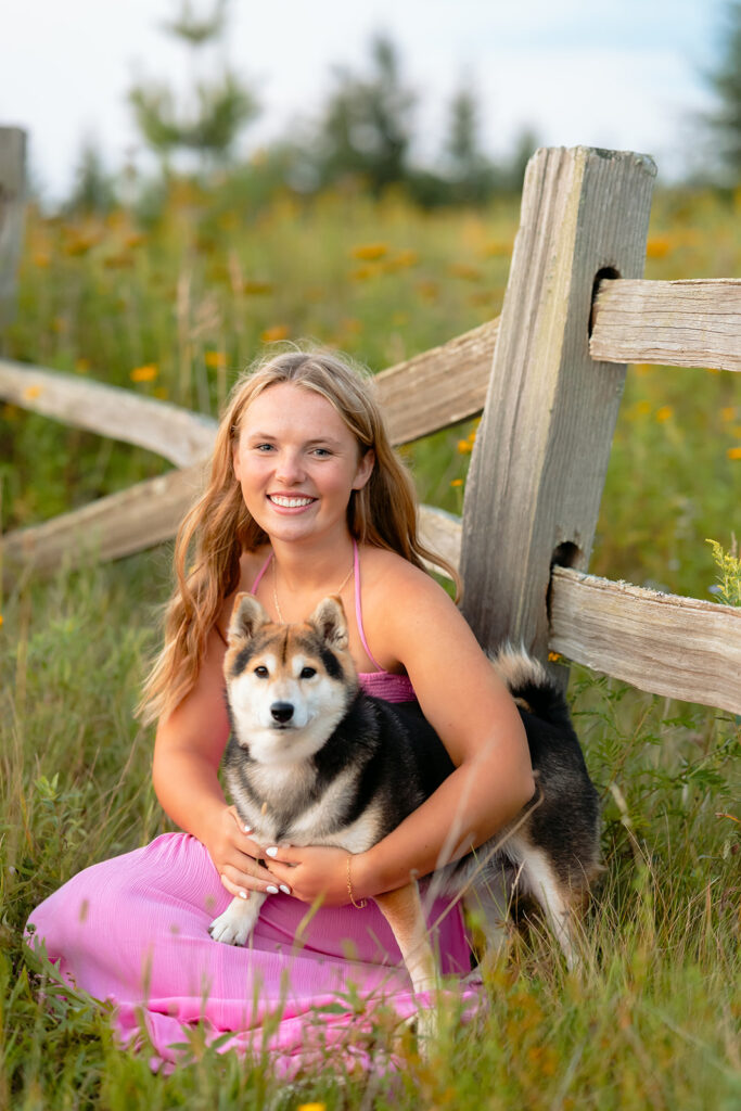 a sweet girl photographed during her minnesota senior photoshoot at a field