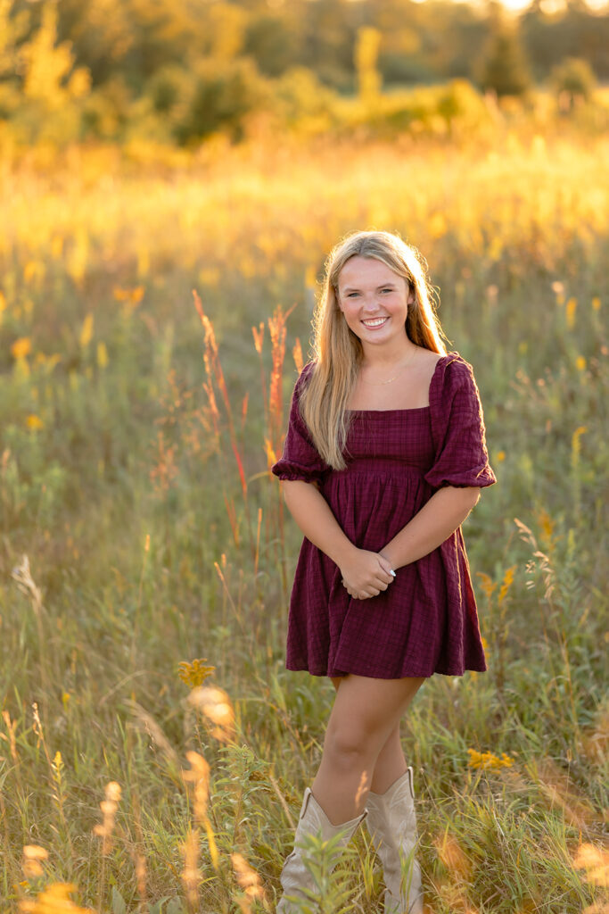a sweet girl photographed during her minnesota senior photoshoot at a field