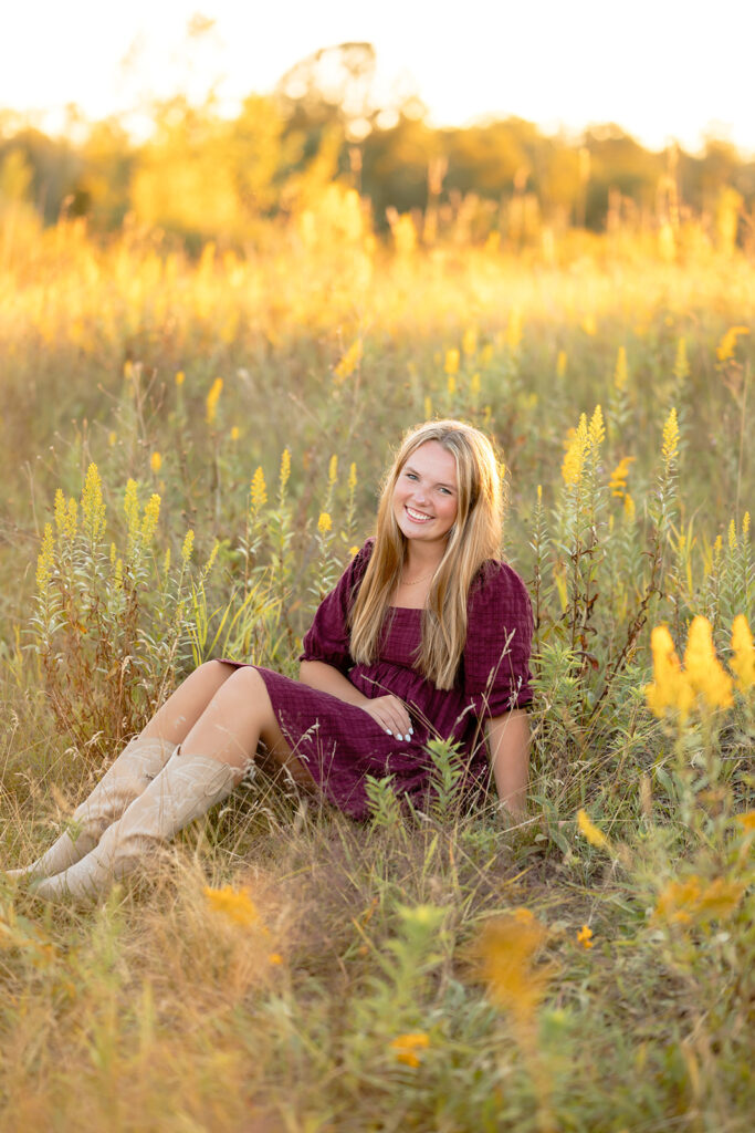 a sweet girl photographed during her minnesota senior photoshoot at a field