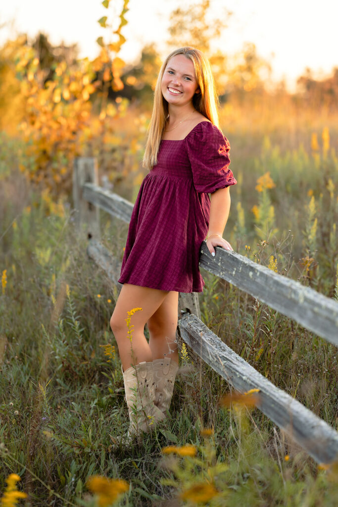 a sweet girl photographed during her minnesota senior photoshoot at a field