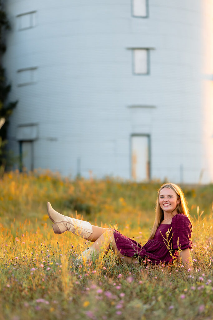 a sweet girl photographed during her minnesota senior photoshoot at a field