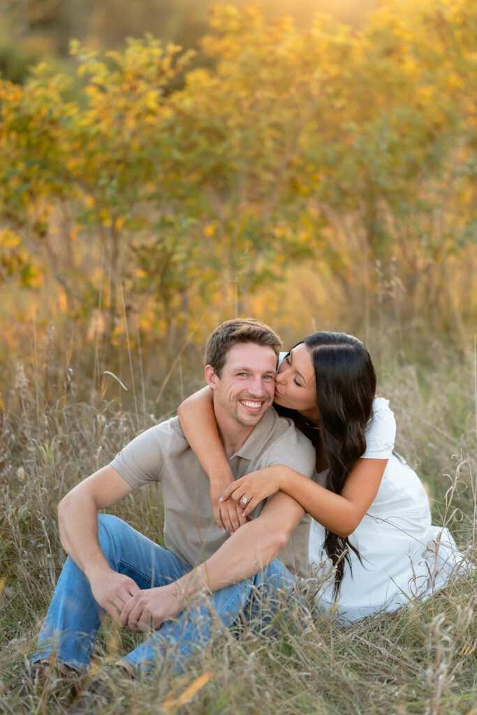 playful and romantic engagement photos in a golden field in bemidji mn