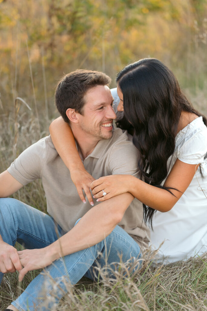 playful romantic engagement photos in a field in bemidji mn