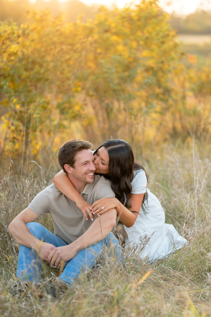 playful and romantic engagement photos in a golden field in bemidji mn
