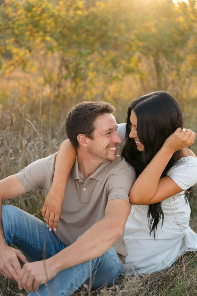 playful and romantic engagement photos in a golden field in bemidji mn
