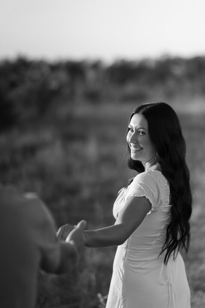 black and white romantic engagement photos in a field in bemidji mn