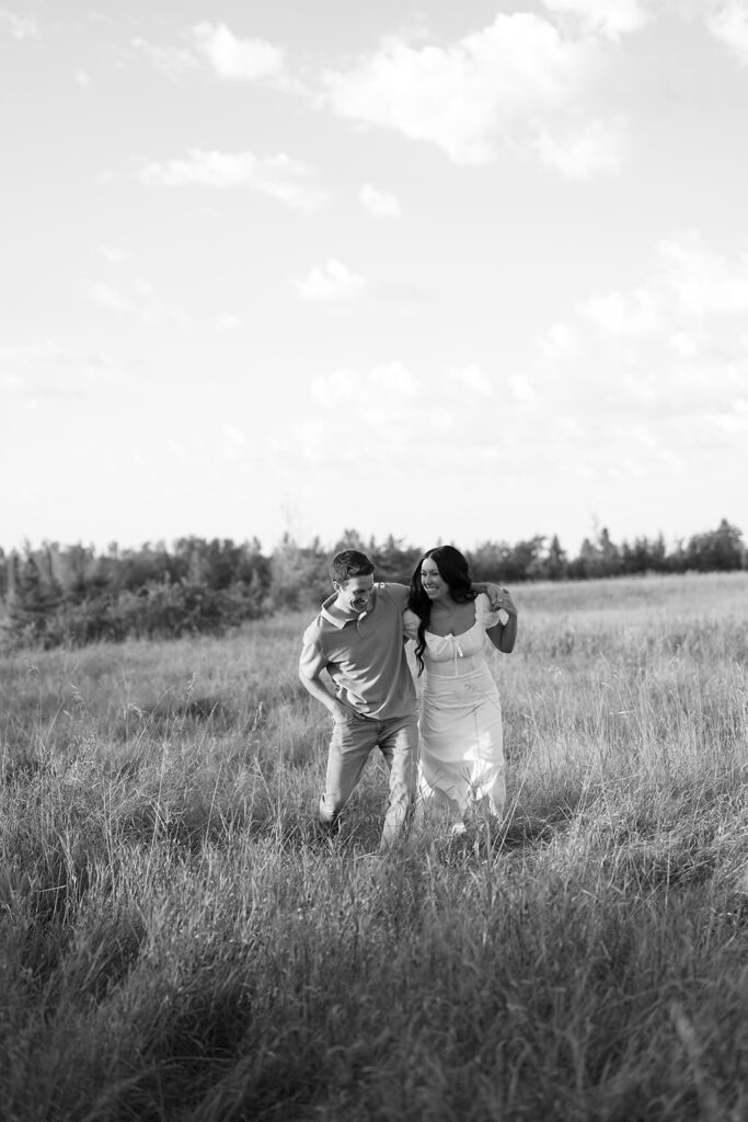 black and white romantic engagement photos in a field in bemidji mn