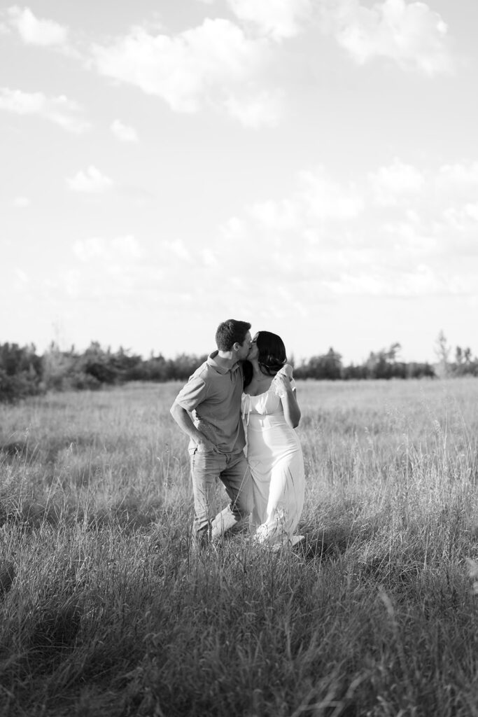 black and white romantic engagement photos in a field in bemidji mn